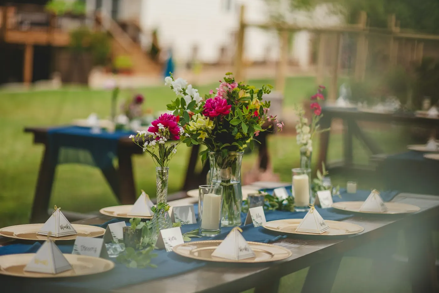 Garden reception tables set with flowers and candles