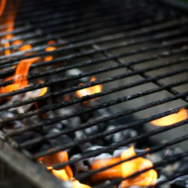 Flames over the coals of a braai