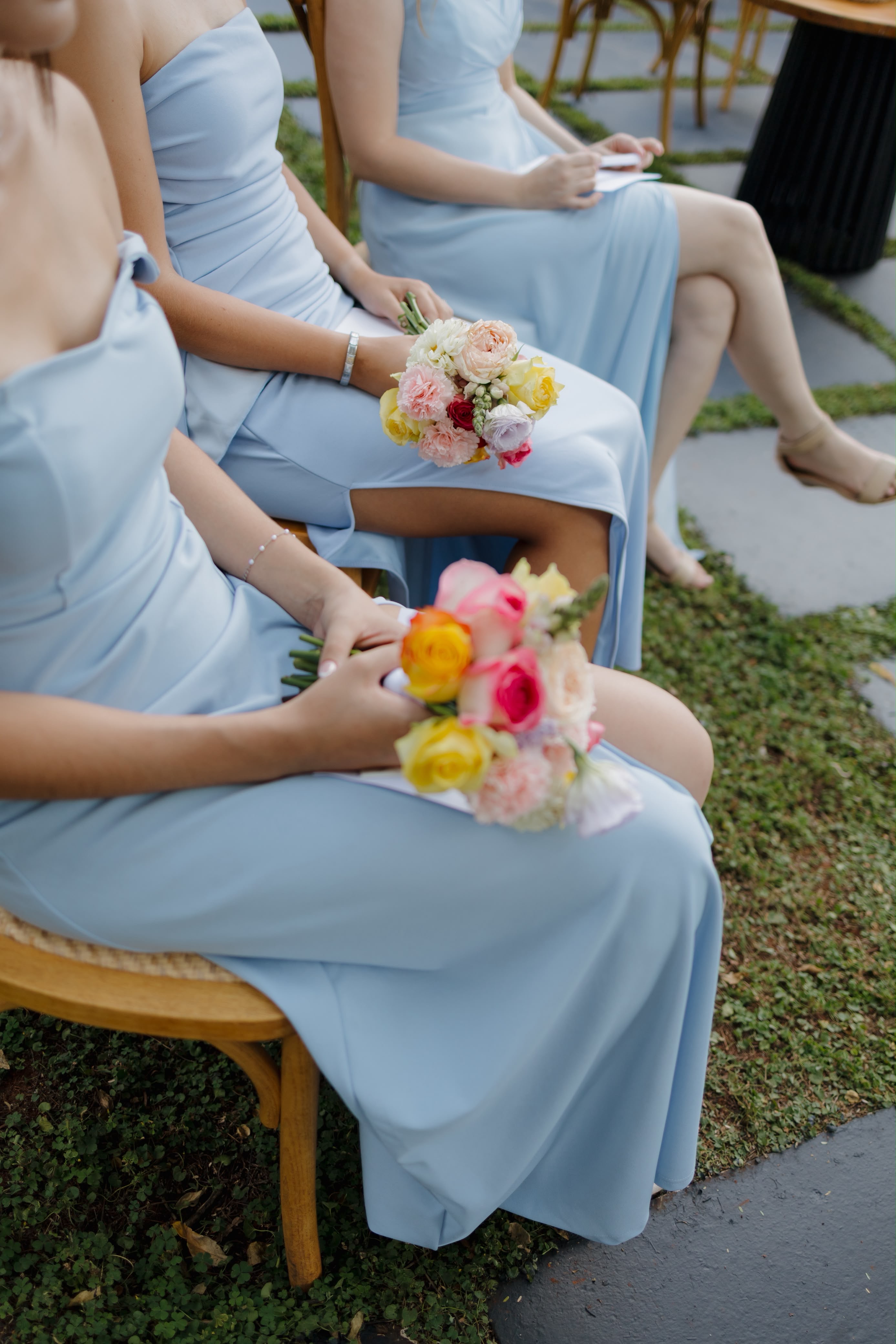 Bridesmaids seated with bright posies