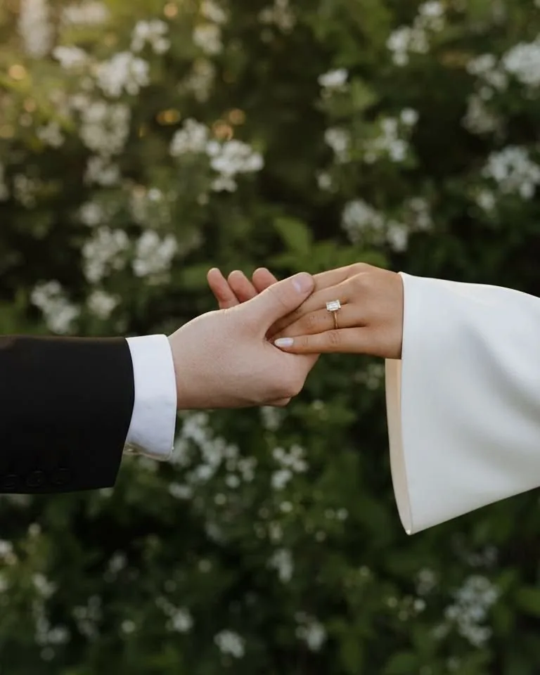 Engaged couple holding hands, showing the ring