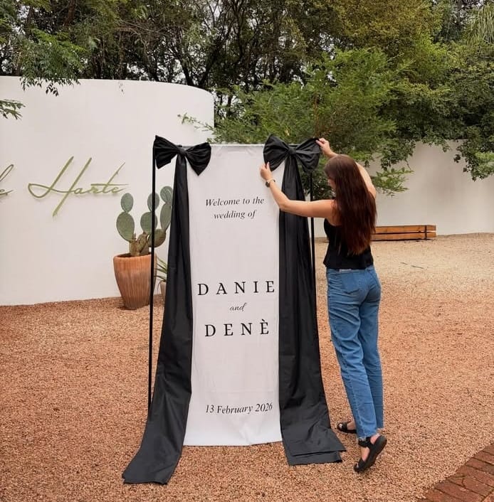Coordinator installing a draped welcome banner