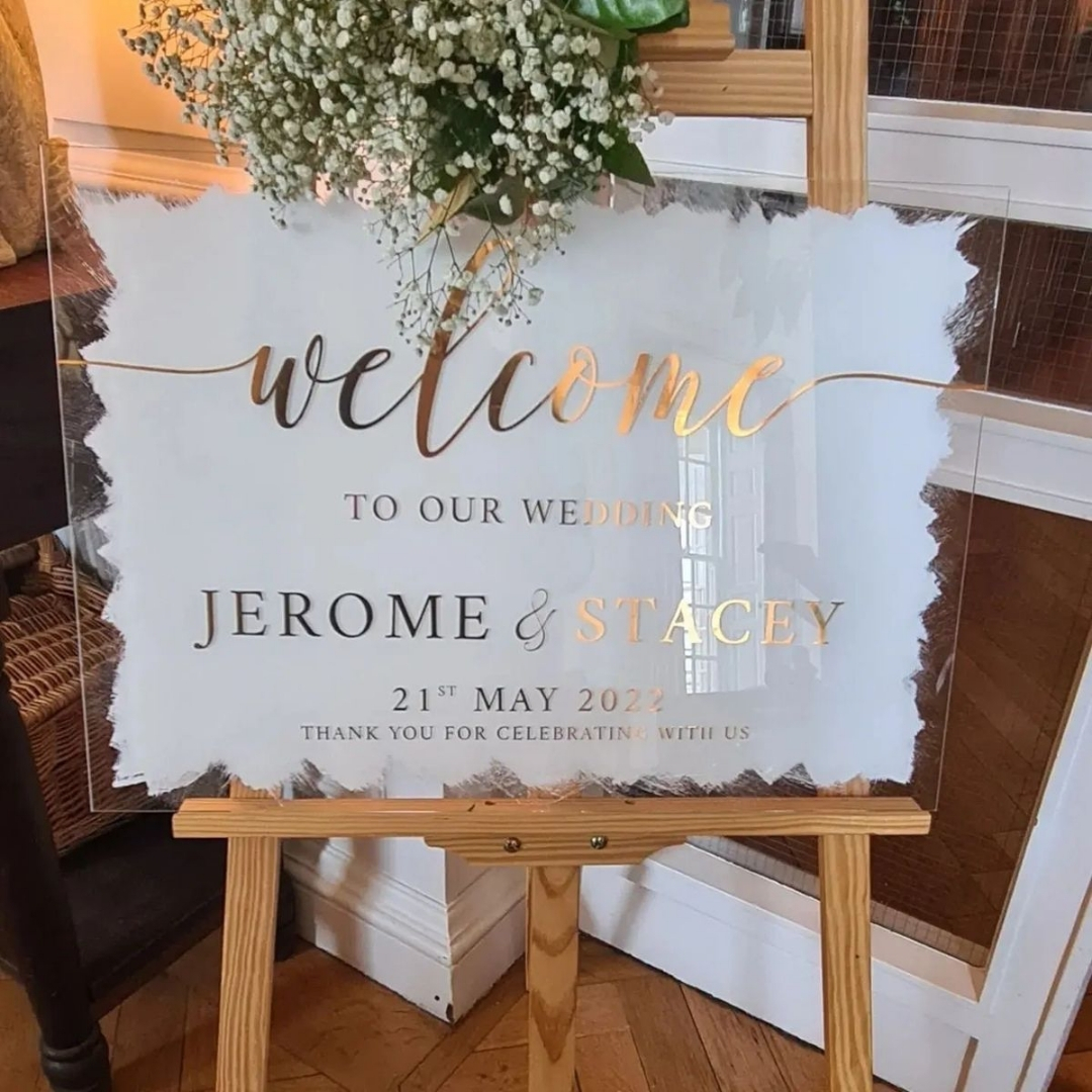 Clear perspex wedding sign on an easel