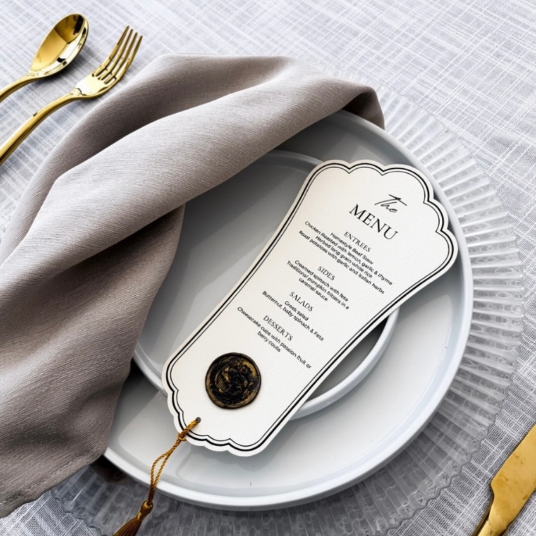 Die-cut menu with a wax seal at a place setting