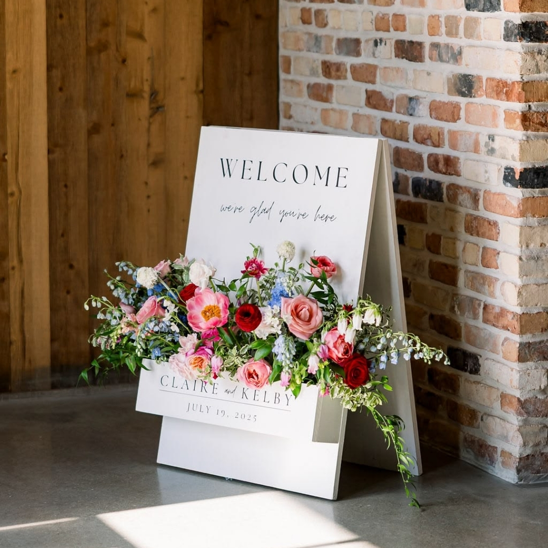 Standing welcome board with a flower box base