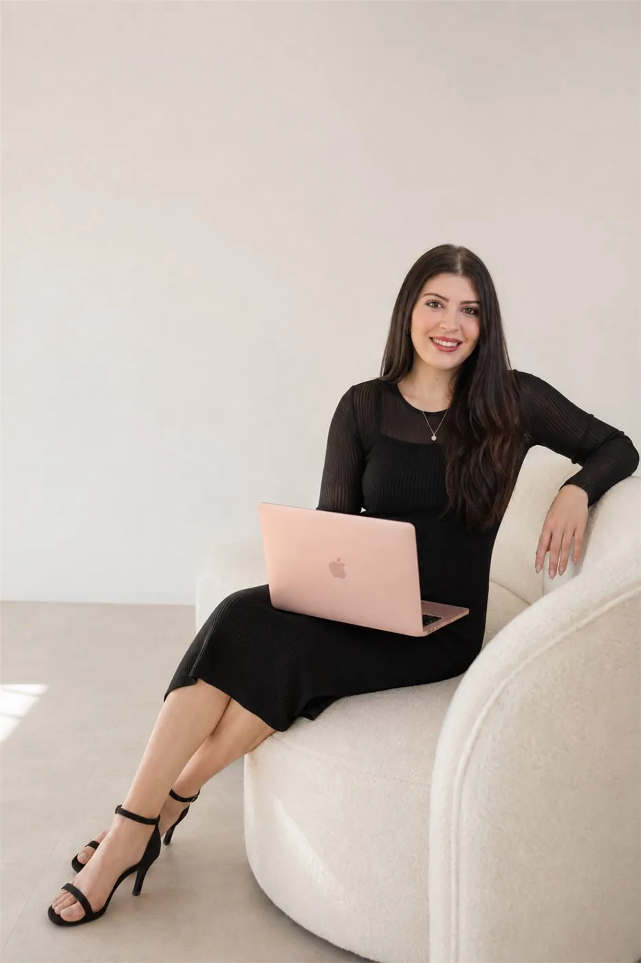 The planner behind Signature Setup & Co, working from a studio armchair